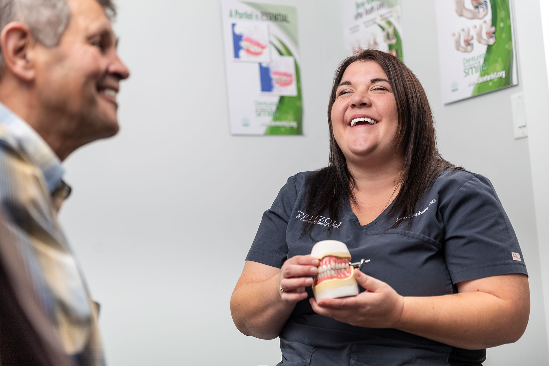 The denturist at Rizzoli Denture & Implant Clinic with a patient