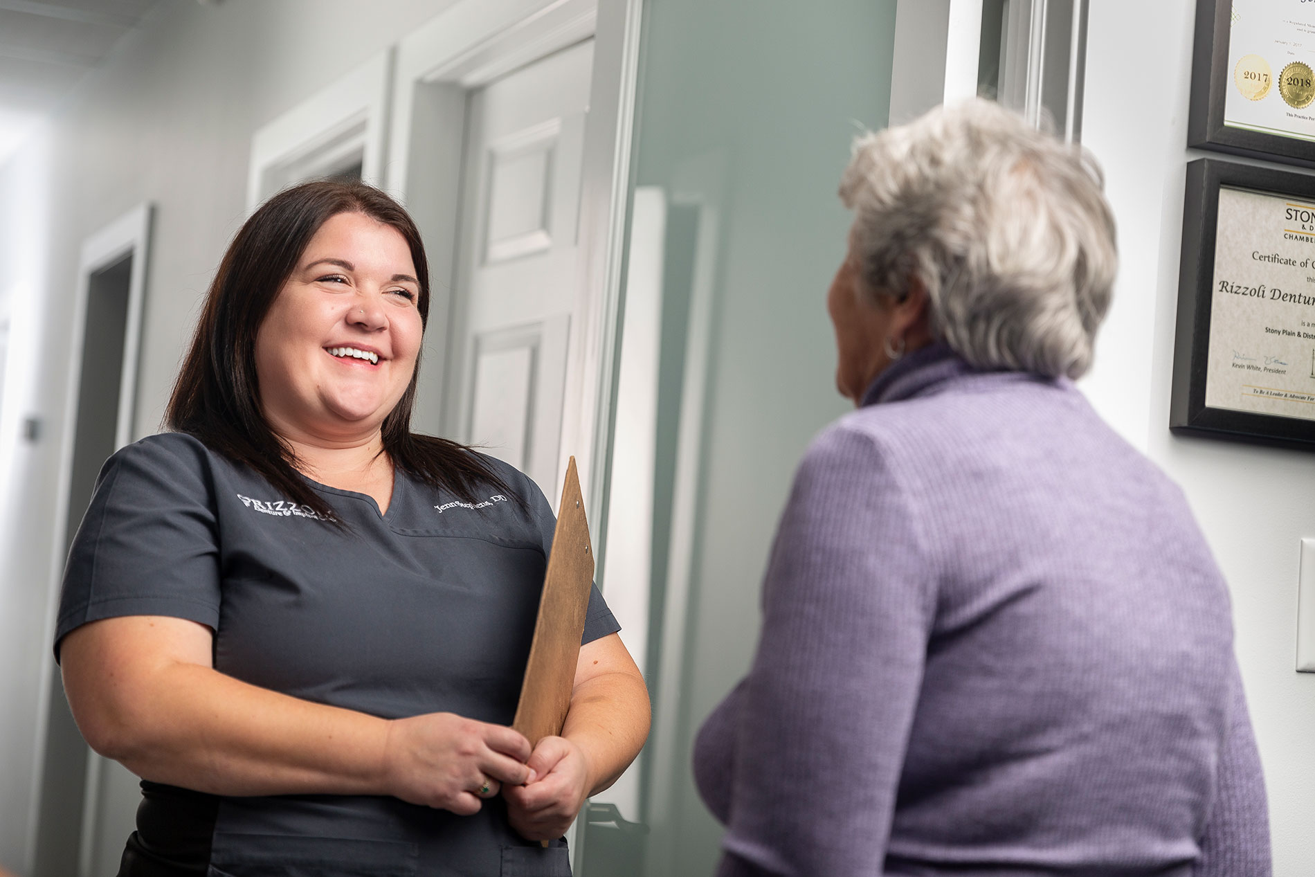 A denturist with her patient at the Rizzioli Denture & Implant Clinic